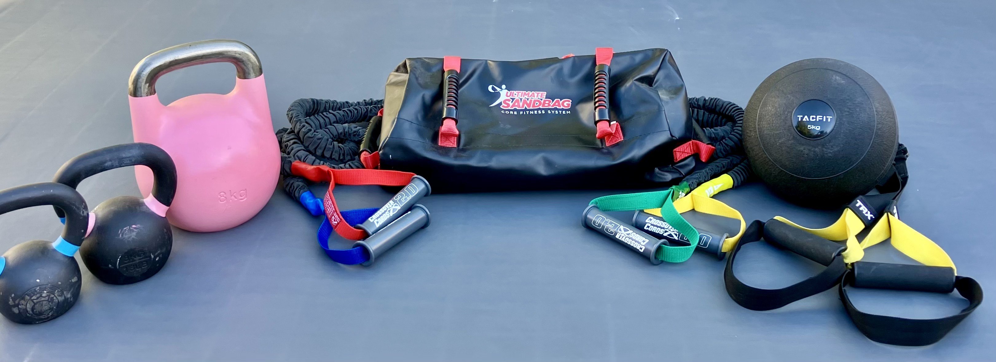 RenSomatics training equipment: kettlebells, resistance bands, sandbag, and TRX straps